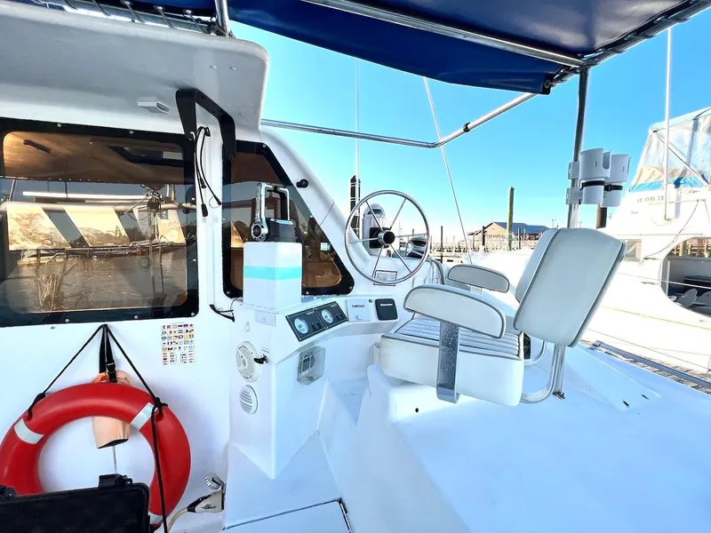 Slide: The Image of Farrier F-41 2007 boat cockpit with steering wheel, control panel, and seating. - 5