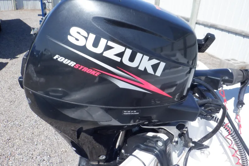 Slide: The Image of Outboard motor on 2015 Walker Bay 325 STX Odyssey boat, featuring Suzuki four-stroke engine. - 28