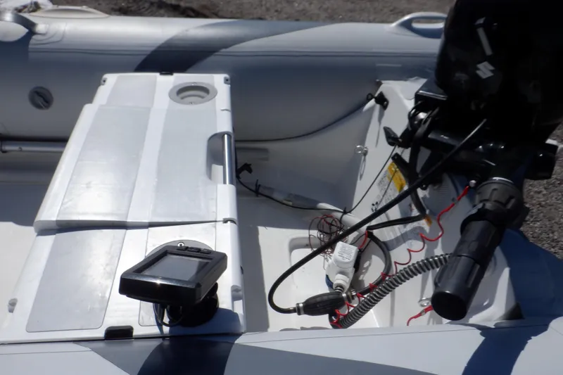 Slide: The Image of 2015 Walker Bay 325 STX Odyssey boat interior with motor and control panel. - 47