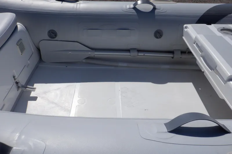 Slide: The Image of Walker Bay 325 STX Odyssey 2015 inflatable boat interior, featuring seating and storage compartments. - 49