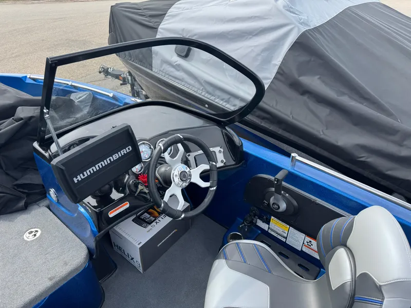 Slide: The Image of 2024 Nitro ZV19 Sport boat cockpit with Humminbird electronics and steering wheel. - 11