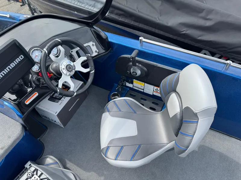 Slide: The Image of 2024 Nitro ZV19 Sport boat cockpit with steering wheel and seat, featuring modern design. - 12