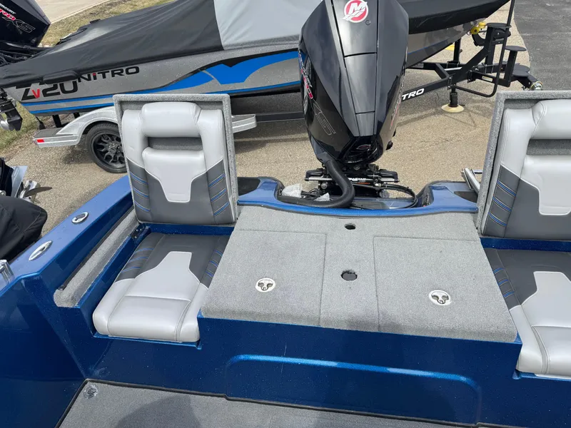 Slide: The Image of 2024 Nitro ZV19 Sport boat interior with motor, featuring gray seating and blue accents. - 13