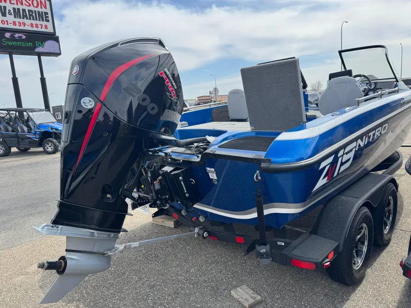 Slide: The Image of 2024 Nitro ZV19 Sport boat with powerful outboard motor, parked on a trailer. - 3
