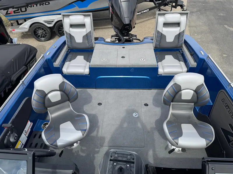Slide: The Image of 2024 Nitro ZV19 Sport boat interior with gray seating and blue accents. - 6