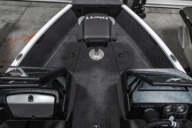Slide: The Image of 2024 Lund 1675 Adventure Sport boat interior with seating and dashboard. - 10