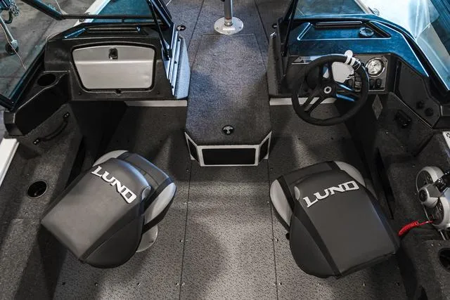 Slide: The Image of 2024 Lund 1675 Adventure Sport boat interior with dual seats and steering console. - 5