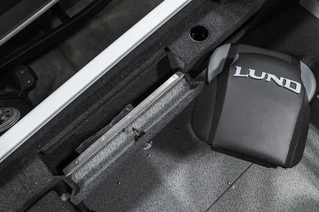 Slide: The Image of 2024 Lund 1675 Adventure Sport boat interior with storage compartment and branded seat. - 9