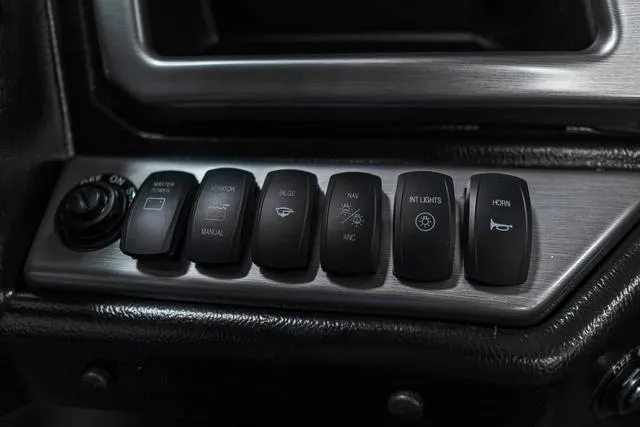 Slide: The Image of Control panel of 2024 Lund 2075 Tyee Sport boat with various switches. - 14