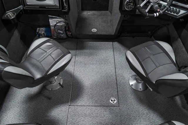 Slide: The Image of 2024 Lund 2075 Tyee Sport boat interior with two swivel seats and carpeted flooring. - 16