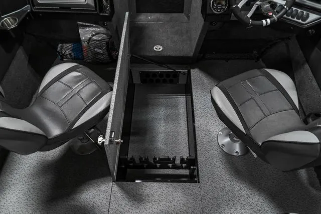 Slide: The Image of 2024 Lund 2075 Tyee Sport boat interior with storage compartment between two seats. - 17