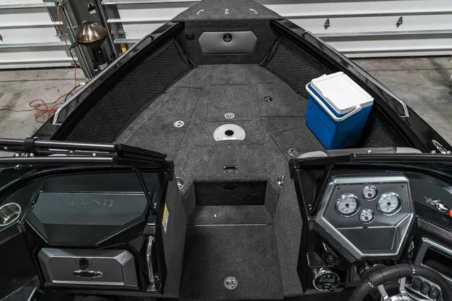 Slide: The Image of 2024 Lund 2075 Tyee Sport boat interior with dashboard and storage compartments. - 18