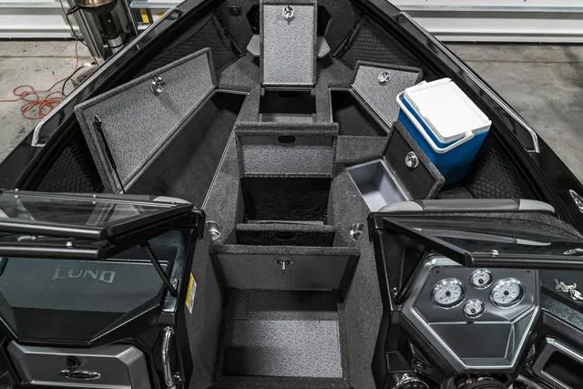 Slide: The Image of 2024 Lund 2075 Tyee Sport boat interior with storage compartments and cooler. - 19
