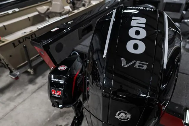 Slide: The Image of 2024 Lund 2075 Tyee Sport boat with Mercury 200 V6 and 9.9 ProKicker engines. - 2