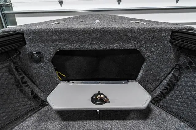 Slide: The Image of 2024 Lund 2075 Tyee Sport boat interior storage compartment with keys. - 20
