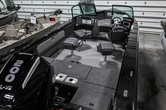 Slide: The Image of 2024 Lund 2075 Tyee Sport boat interior with Mercury 200 engine in showroom. - 3
