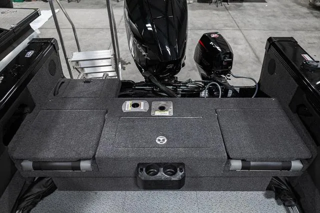 Slide: The Image of 2024 Lund 2075 Tyee Sport boat interior with motor and seating. - 4