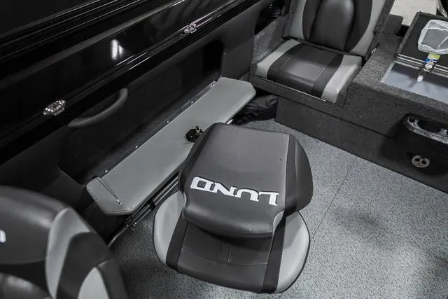Slide: The Image of 2024 Lund 2075 Tyee Sport boat interior with seating and storage compartments. - 6