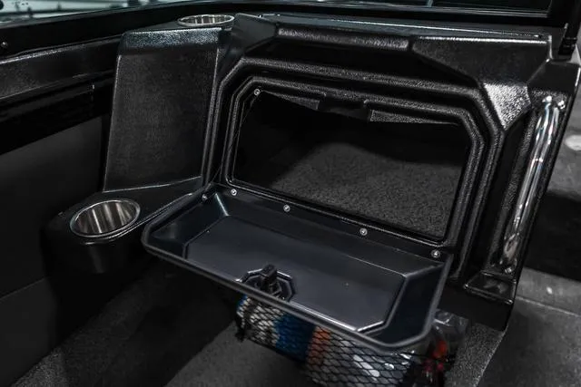 Slide: The Image of 2024 Lund 2075 Tyee Sport boat interior storage compartment with cup holder. - 9