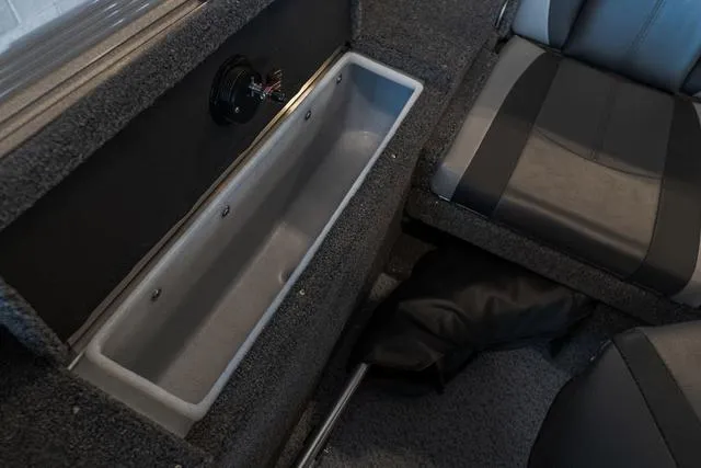 Slide: The Image of 2024 Lund 1775 Impact XS Sport boat interior with open storage compartment. - 12
