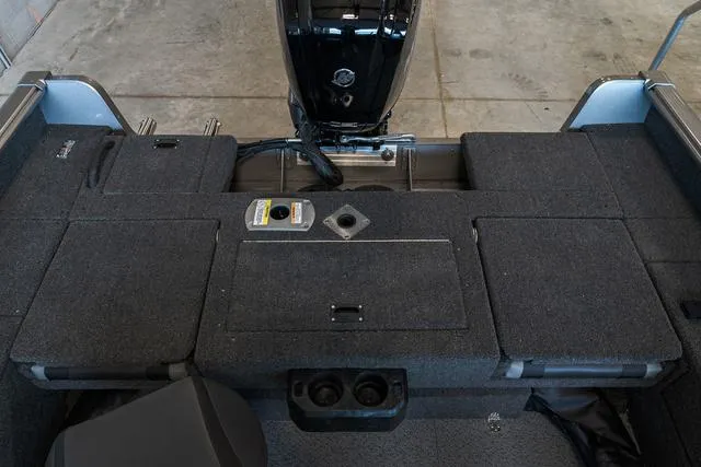 Slide: The Image of 2024 Lund 1775 Impact XS Sport boat interior with storage compartments. - 13