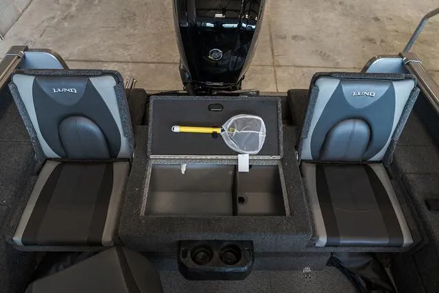 Slide: The Image of 2024 Lund 1775 Impact XS Sport boat interior with open storage compartments. - 14