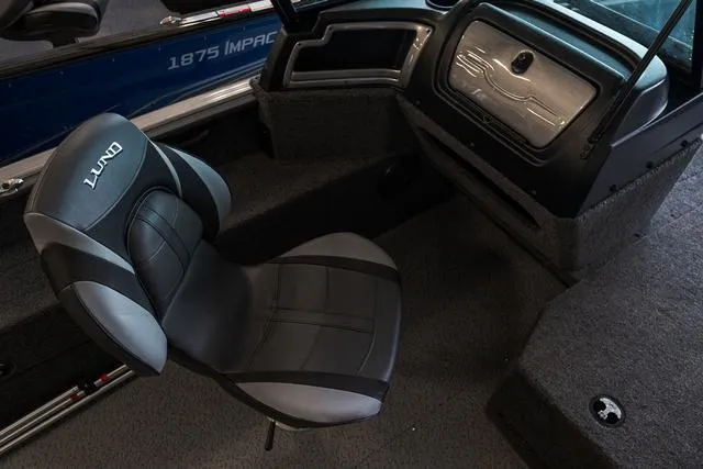 Slide: The Image of 2024 Lund 1775 Impact XS Sport boat interior with cushioned seating and storage. - 16