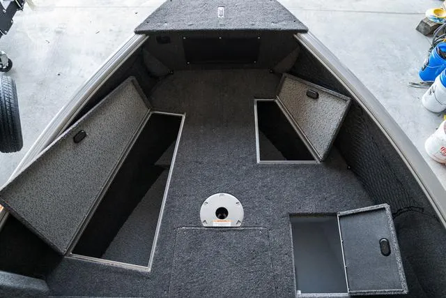Slide: The Image of 2024 Lund 1775 Impact XS Sport boat interior with open storage compartments. - 19