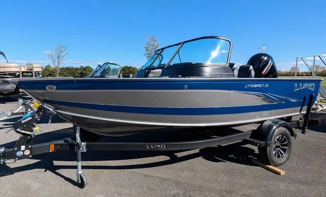 Slide: The Image of 2024 Lund 1775 Impact XS Sport boat interior with steering wheel and captain's chair. - 3