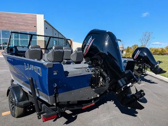 Slide: The Image of 2024 Lund 1775 Impact XS Sport dashboard controls and audio system. - 5