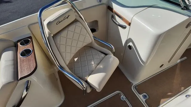 Slide: The Image of 2017 Chris-Craft 27 Launch boat interior seating with storage compartment. - 22