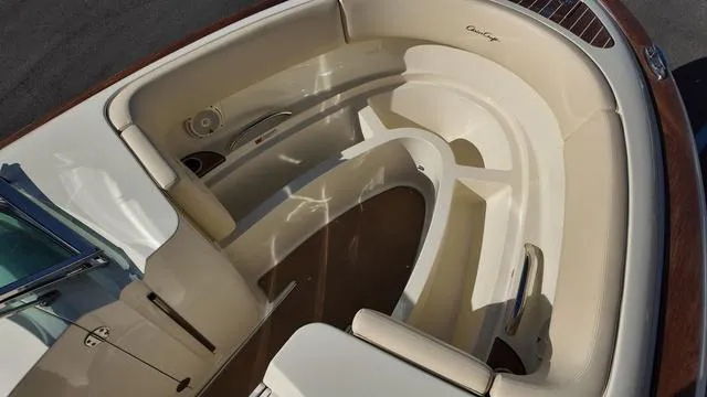 Slide: The Image of 2017 Chris-Craft 27 Launch boat interior with elegant beige seating and wood accents. - 28