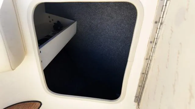 Slide: The Image of 2017 Chris-Craft 27 Launch storage compartment with open hatch. - 29