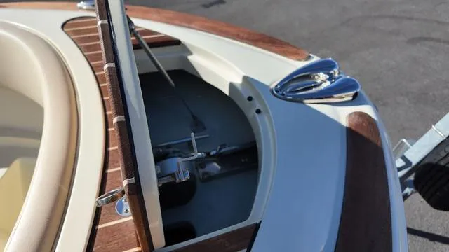 Slide: The Image of 2017 Chris-Craft 27 Launch boat with open storage compartment and polished chrome details. - 31