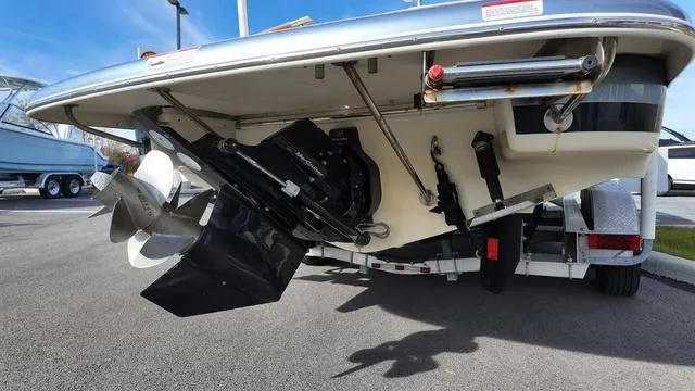 Slide: The Image of 2017 Chris-Craft 27 Launch boat interior with beige diamond-stitched seating and wooden accents. - 5