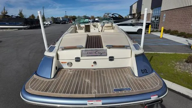 Slide: The Image of 2017 Chris-Craft 27 Launch boat interior with beige leather seating and storage compartments. - 6