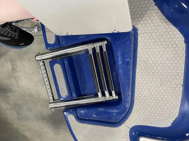 Slide: The Image of 2010 Bryant 210 BR boat interior with white and blue seating. - 10