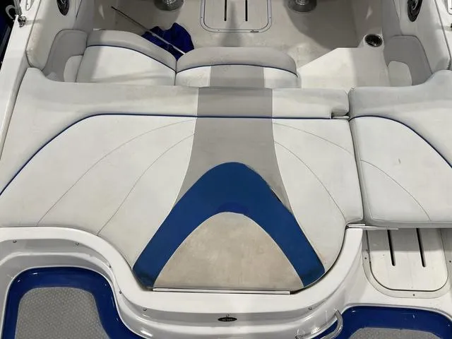 Slide: The Image of 2010 Bryant 210 BR boat interior seating with white and blue upholstery. - 11