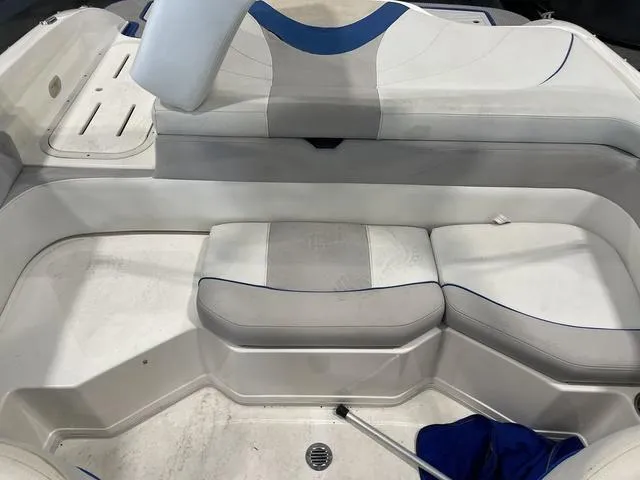 Slide: The Image of 2010 Bryant 210 BR boat interior with white and blue seating. - 14