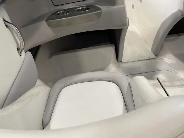 Slide: The Image of 2010 Bryant 210 BR boat interior with white seating and blue accents. - 19