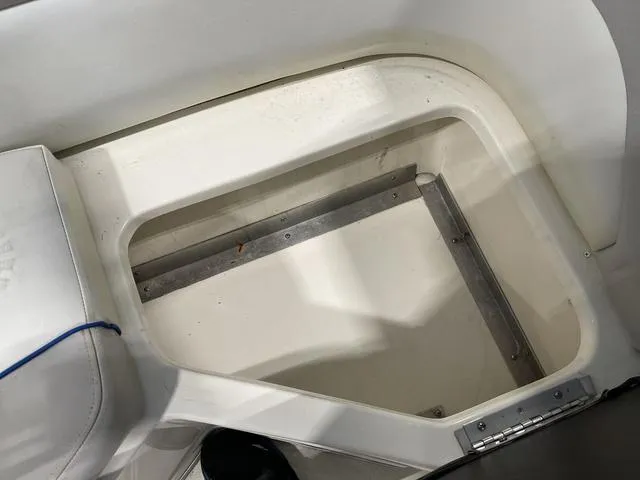 Slide: The Image of 2010 Bryant 210 BR boat interior with engine compartment and seating area. - 23