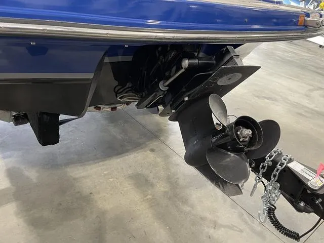 Slide: The Image of 2010 Bryant 210 BR boat with propeller and trailer hitch in a garage. - 26