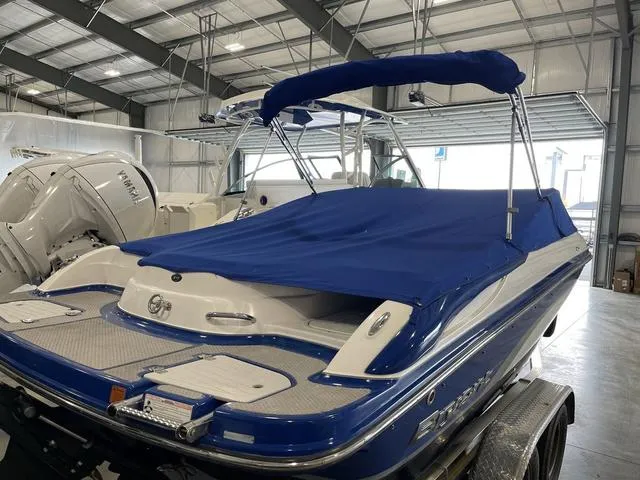 Slide: The Image of 2010 Bryant 210 BR boat on a trailer in a storage facility. - 4