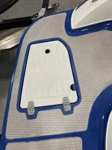 Slide: The Image of 2010 Bryant 210 BR boat storage compartment with blue interior and white lid. - 7