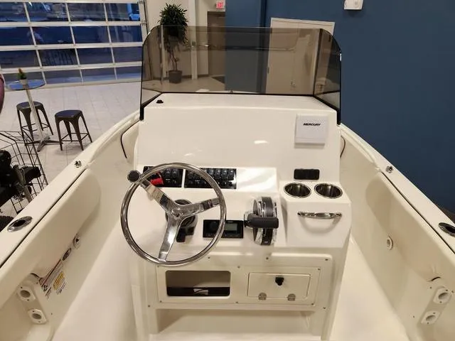 Slide: The Image of 2023 Stingray 173CC boat console with steering wheel and controls in showroom. - 10