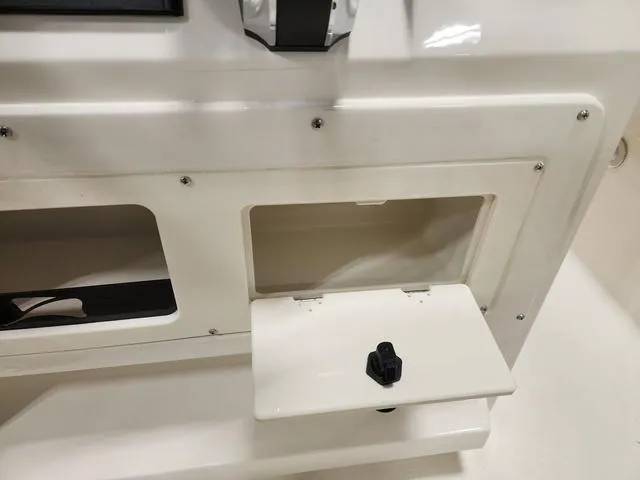 Slide: The Image of 2023 Stingray 173CC boat storage compartment with open hatch. - 11