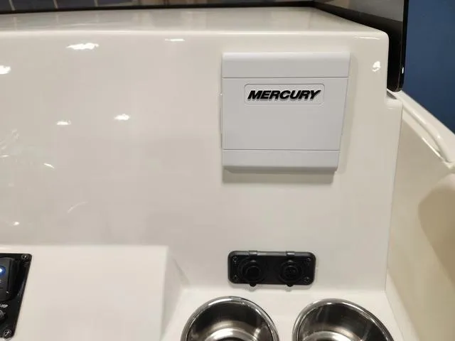 Slide: The Image of 2023 Stingray 173CC boat console with Mercury control panel and cup holders. - 16