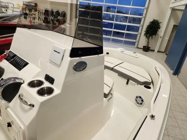 Slide: The Image of 2023 Stingray 173CC boat interior with console, cup holders, and seating. - 18