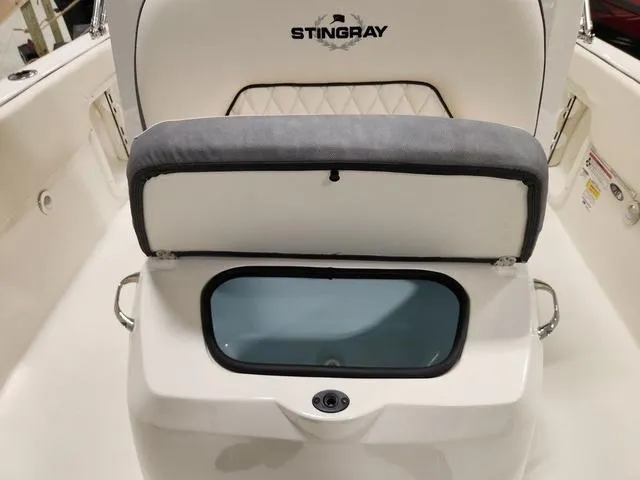 Slide: The Image of 2023 Stingray 173CC boat interior with cushioned seating and storage compartment. - 24