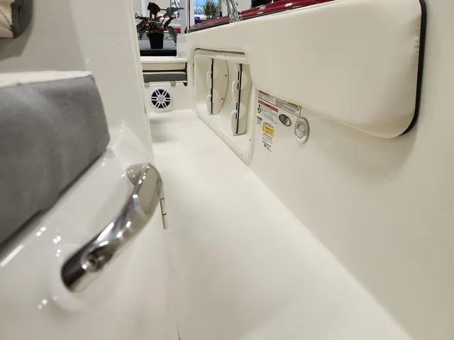 Slide: The Image of 2023 Stingray 173CC boat interior, white seating and storage compartments. - 27